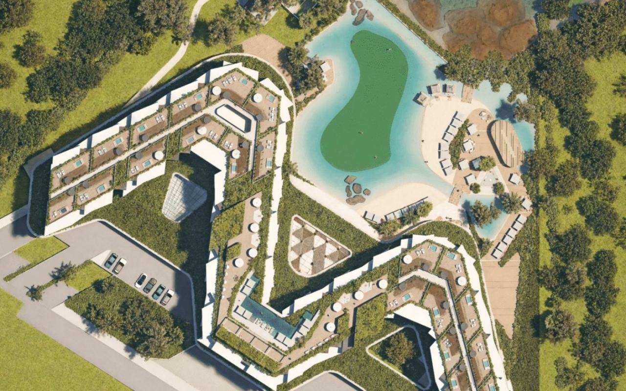 Recreación en planta de Makai Residences: las azoteas privadas de sus 216 residencias sobre el patio, la piscina laguna y el estacionamiento comunes.