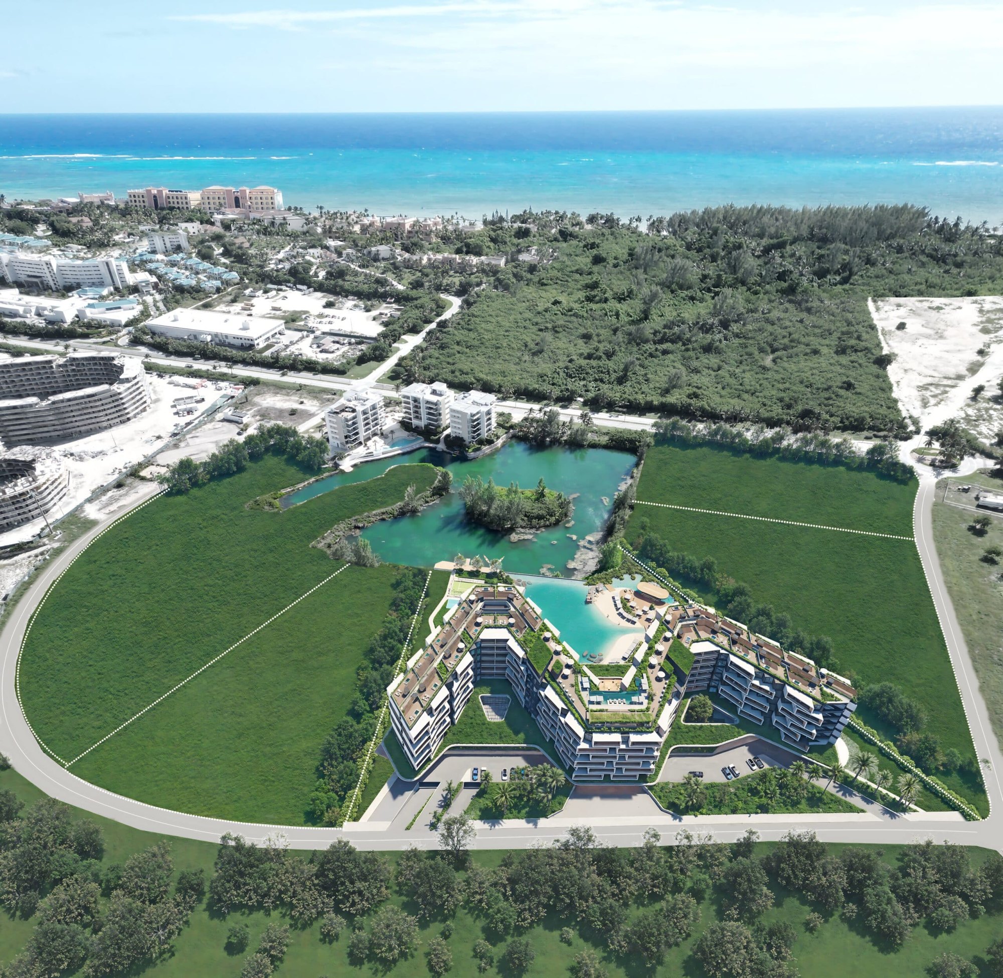 Vue aérienne en image de synthèse de Makai Residences sur sa parcelle de Cap Cana, le lac naturel derrière et l'océan au-delà, à 1 600 pieds de Playa Caracol.