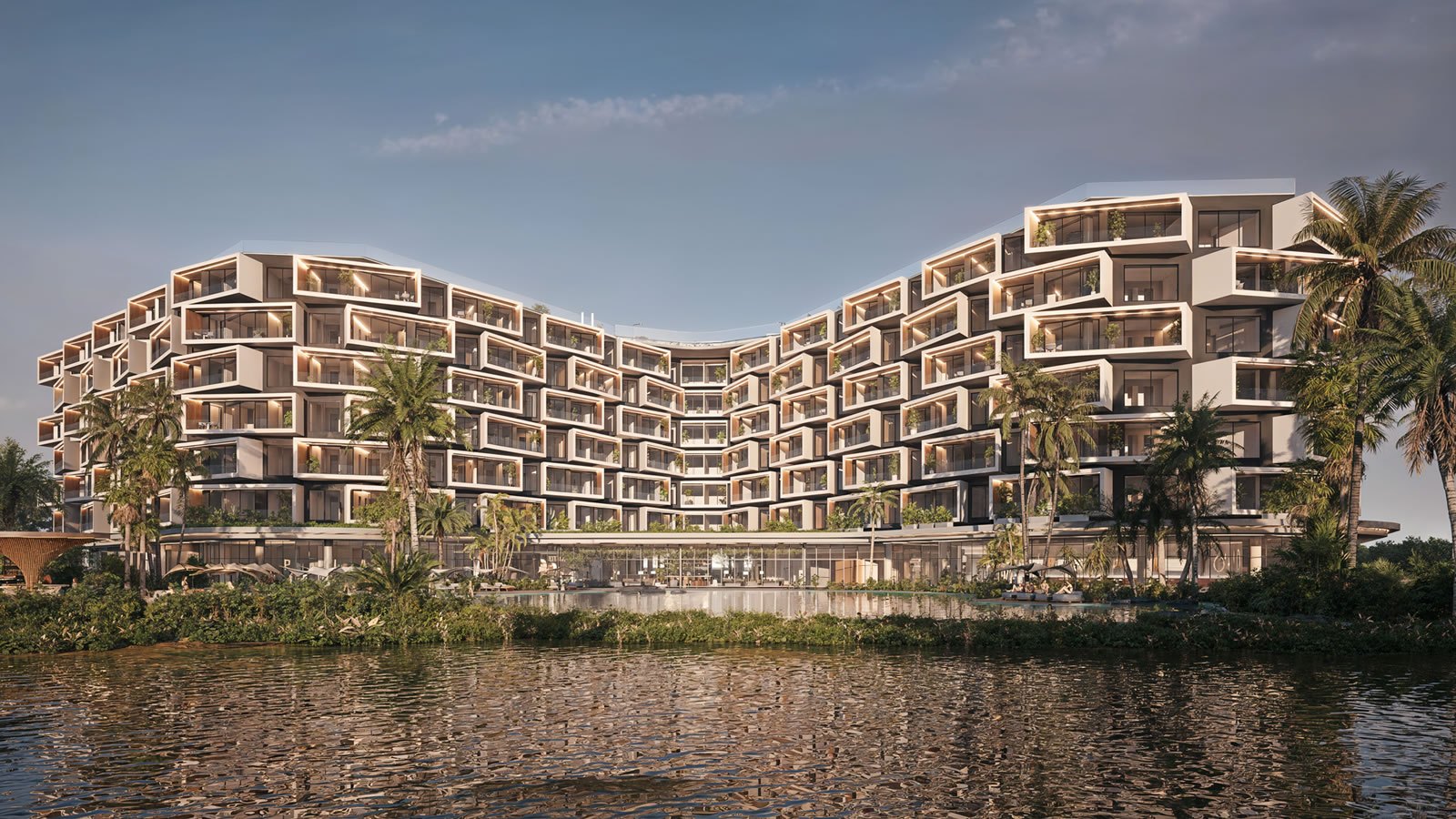 Recreación de Makai Residences vista desde el lago natural: las dos alas en chevron apilan 216 residencias detrás de la vegetación de la orilla.