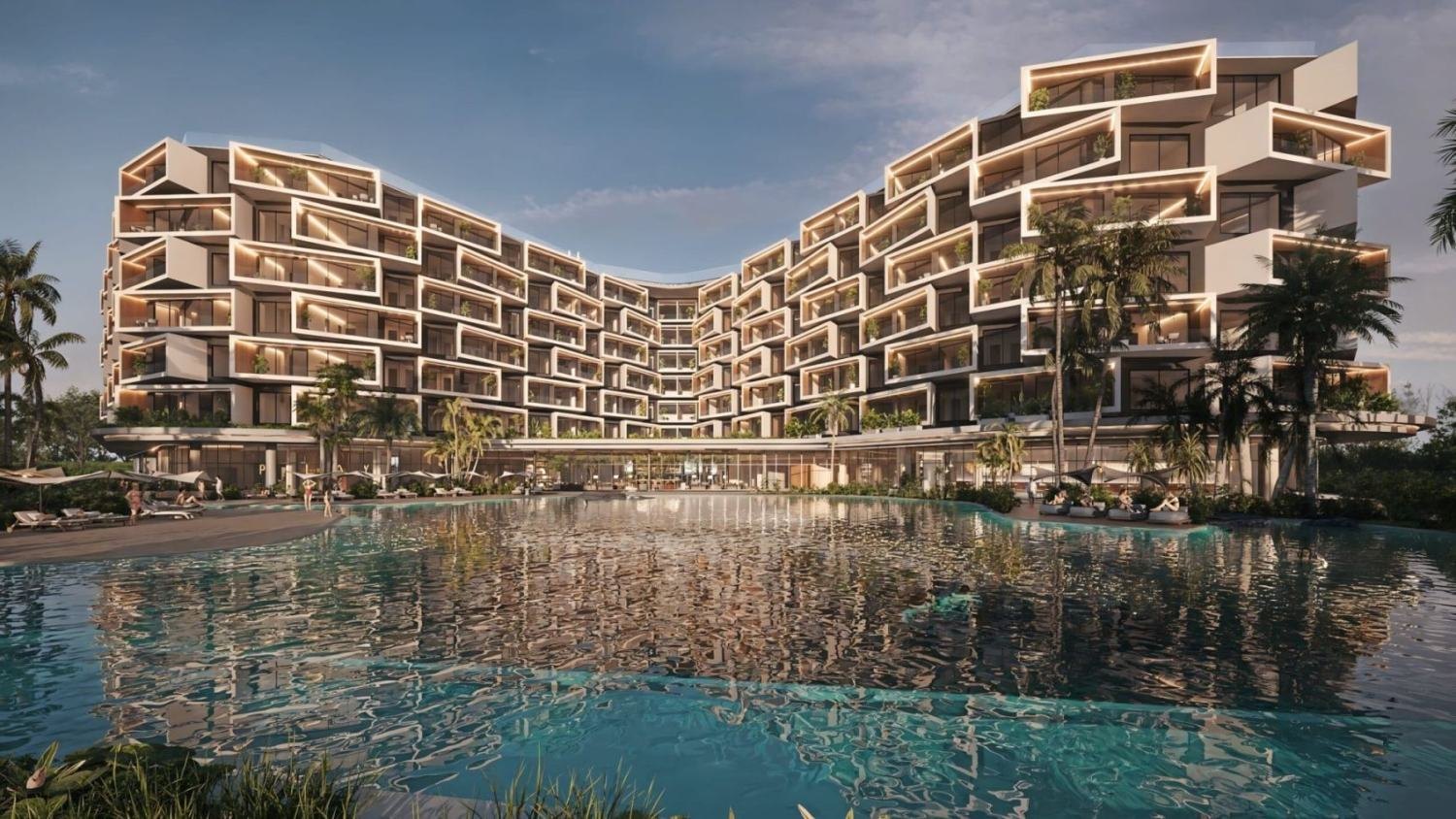 Recreación de las dos alas de Makai Residences, en Cap Cana, vistas de frente sobre una piscina en calma; el edificio reúne 216 residencias.